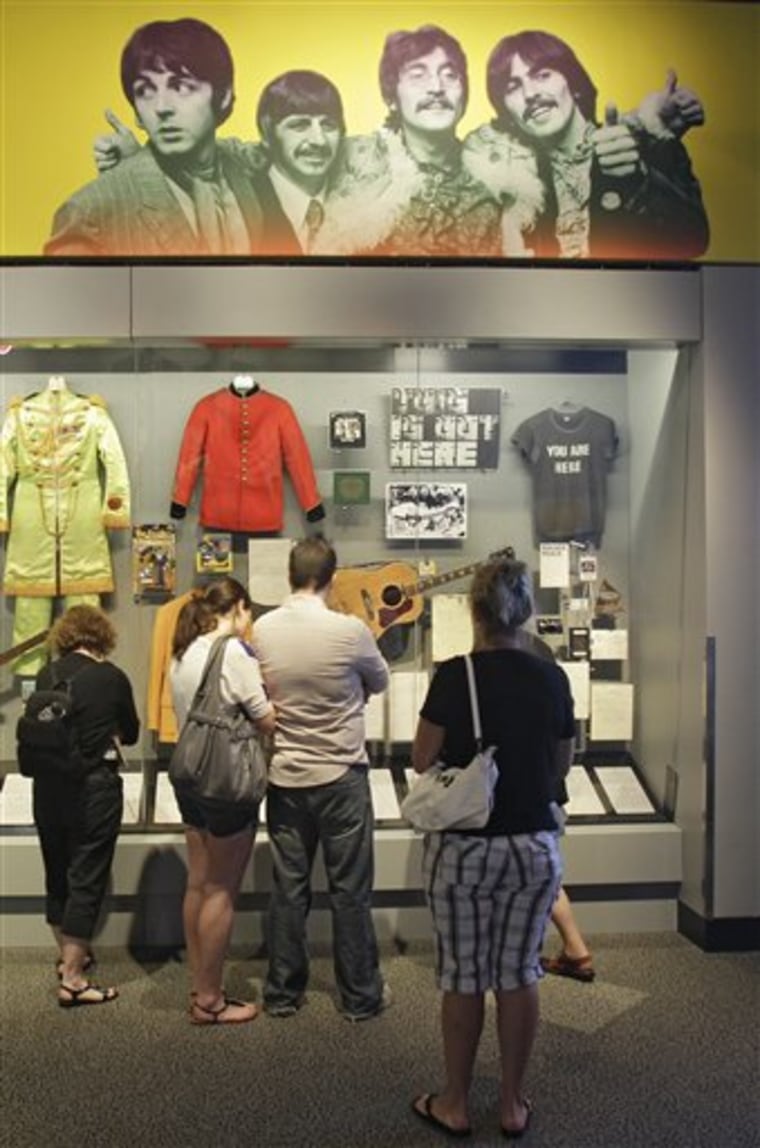 Visitors view an exhibit on The Beatles, at the Rock and Roll Hall of Fame and Museum in Cleveland. The Rock Hall says the exhibit is the world's largest collection of items from the group, as part of a redesign. 